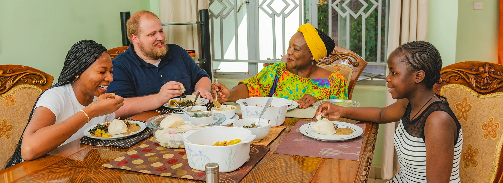 tourist enjoying home cooked meal at a zambian home
