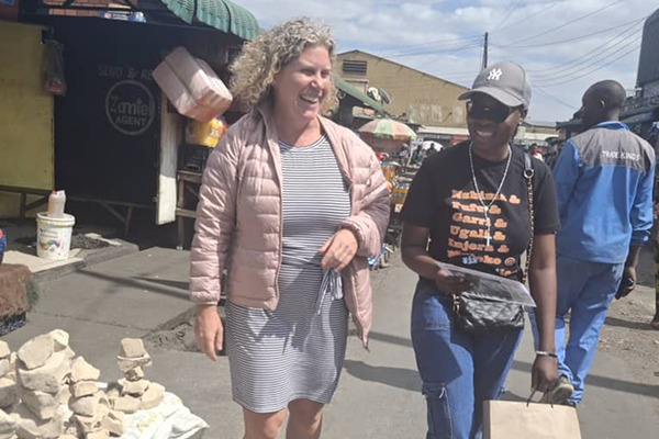 two women walking in an african market on a food tour