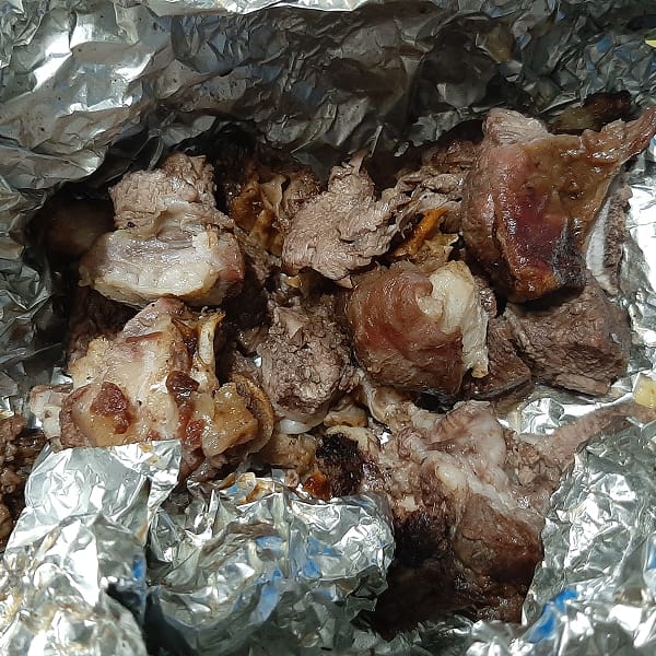 close up of foil wrapped roasted goat or nyama ya mbuzi