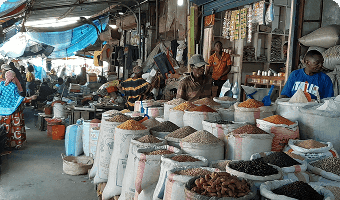 african market displaying many sacks of dried foods for sale