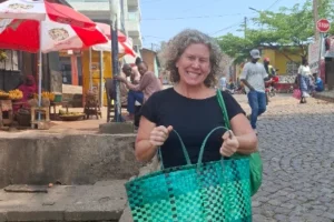 woman standing in nyamirambo with a green shopping bag