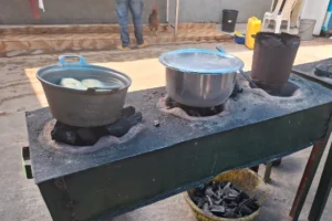 two metal pots on a traditional charcoal stove