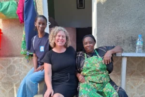three women sit at a home in kigali