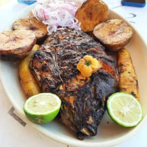 plate with whole grilled fish and lemon in kigali