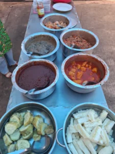 a table displaying pots of several traditional rwandan dishes