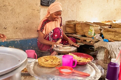 woman cooks chapati in mombasa