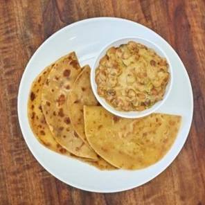 chapati and mbaazi za nazi on a whiite plate