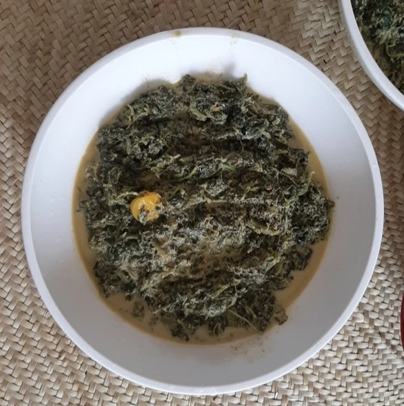 white bowl of swahili spinach with coconut sauce